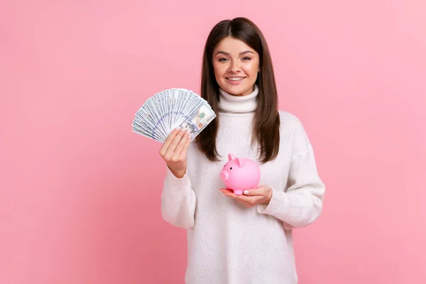 Optimistic Brunette Female Holding Fan Dollar Bills Piggy Bank Savings — 스톡 사진