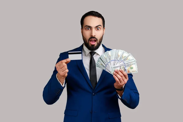 Portrait Astonished Bearded Businessman Holding Credit Card Lot Money Being — Stok fotoğraf