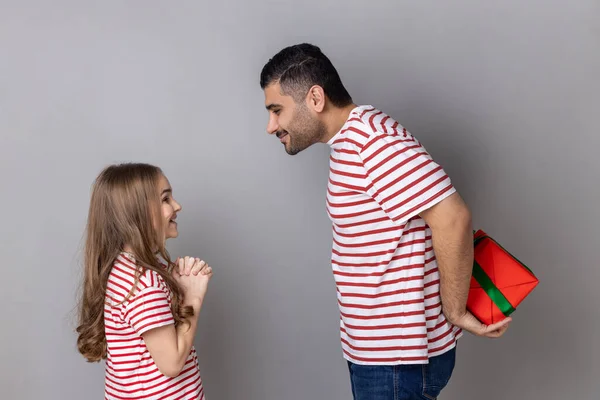 Portrait Happy Festive Father Daughter Striped Shirts Man Hiding Gift —  Fotos de Stock