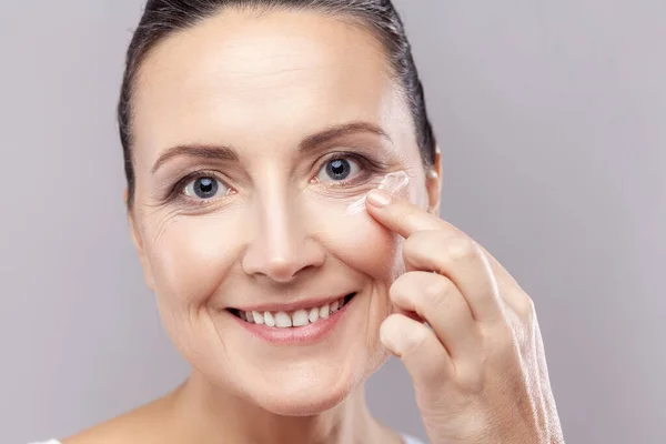 Closeup Portrait Middle Aged Woman Applies Face Cream Enjoys New — Stock Photo, Image