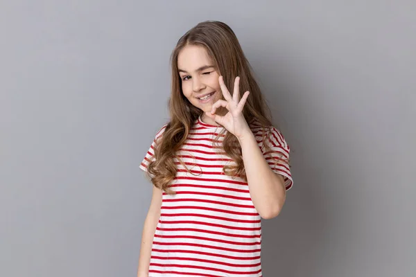 Portrait Playful Adorable Little Girl Wearing Striped Shirt Showing Sign — ストック写真