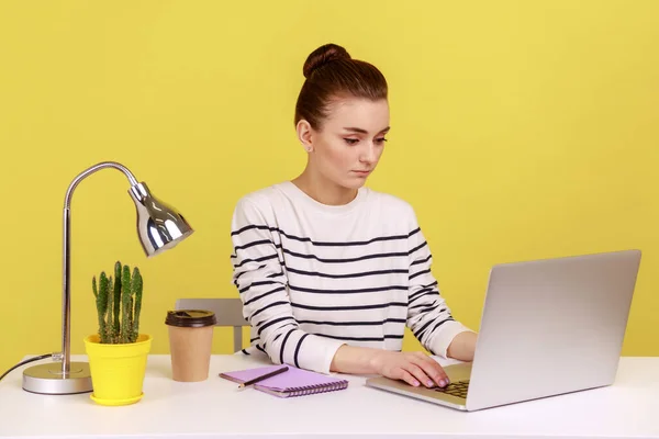 Clever Businesswoman Striped Shirt Sitting Workplace Seriously Looking Laptop Monitor — стоковое фото