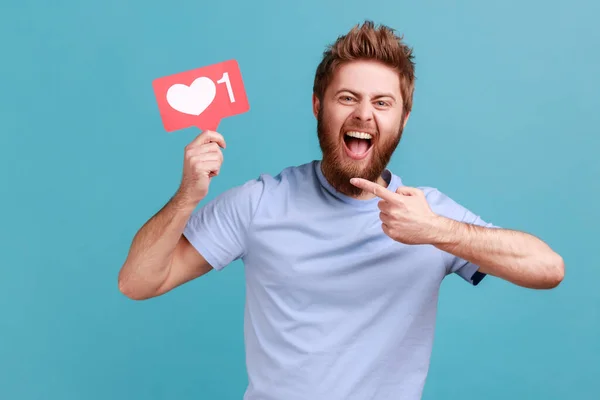 Portrait Excited Positive Bearded Man Pointing Red Counter Sign Asking — Stockfoto