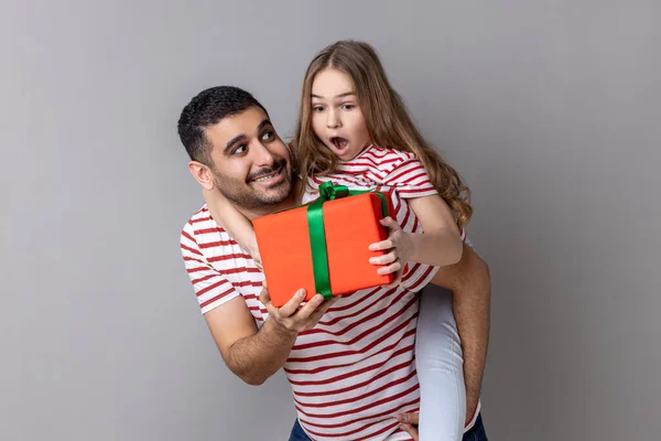Portrait Pleased Father Holding His Surprised Daughter His Back Giving —  Fotos de Stock