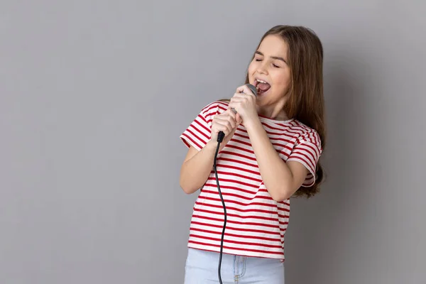 Portrait Positive Little Girl Wearing Striped Shirt Singing Songs Holding — Stockfoto