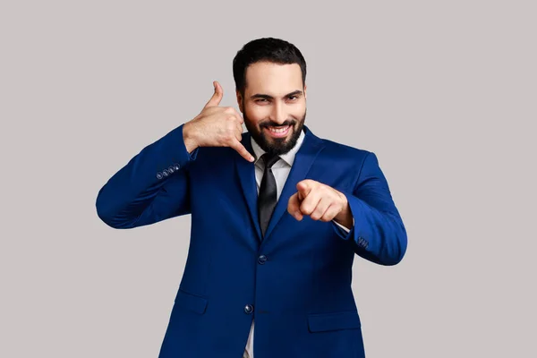 Delighted Bearded Man Standing Telephone Hand Gesture Smiling Camera Flirting — Stok Foto