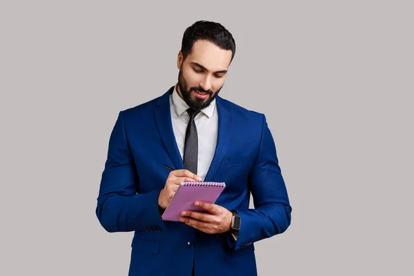 Portrait Positive Bearded Businessman Writing Paper Notebook Making List Having — Photo