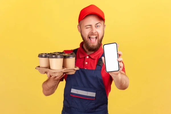 Portrait Playful Childish Courier Man Wearing Blue Overalls Holding Smartphone — Stock Fotó