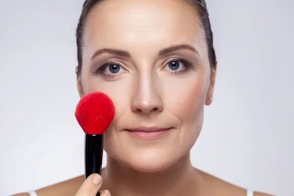 Closeup Portrait Attractive Middle Aged Woman Applies Blush Makeup Brush — Stock Photo, Image