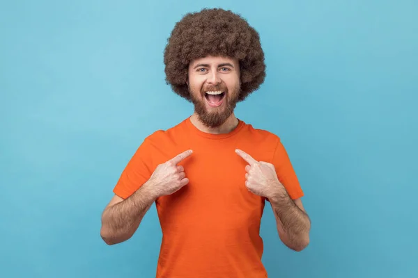 Portrait Egoistic Selfish Man Afro Hairstyle Orange Shirt Pointing Himself — Fotografia de Stock