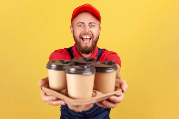 Delivery Service Friendly Happy Courier Man Blue Overalls Offering Coffee — Zdjęcie stockowe