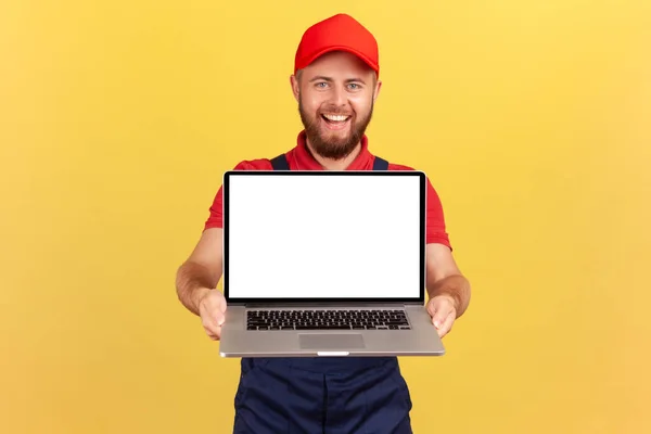 Portrait Delighted Handsome Worker Man Red Cap Holding Laptop Showing — Stock Photo, Image