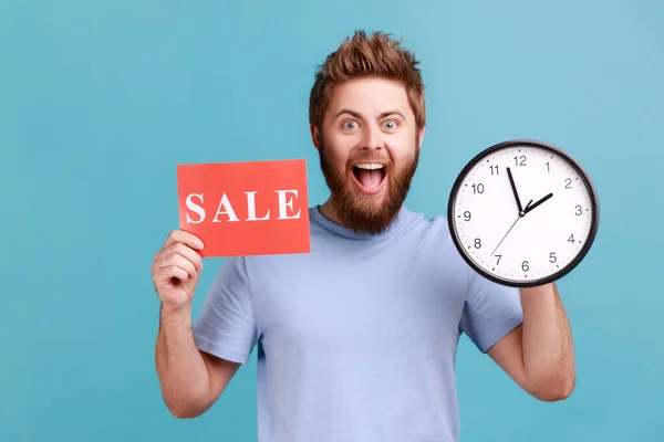 Portrait Excited Positive Handsome Bearded Man Holding Clock Card Sale — 图库照片