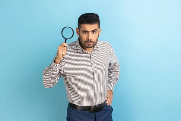 Serious Man Beard Looking Camera Holding Magnifying Glass Spying Finding – stockfoto