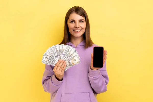 Positive Satisfied Dark Haired Woman Holding Dollar Banknotes Cell Phone — Stock fotografie