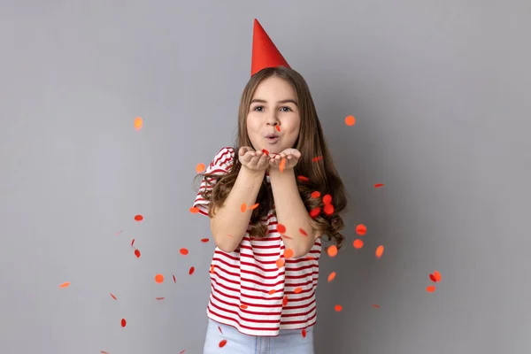 Portrait Happy Little Girl Wearing Striped Shirt Party Cone Blowing — Fotografia de Stock