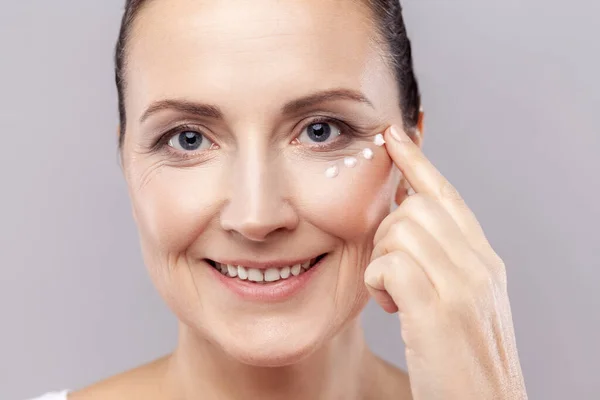 Closeup Portrait Charming Relaxed Middle Aged Woman Applies Face Cream — Stok Foto