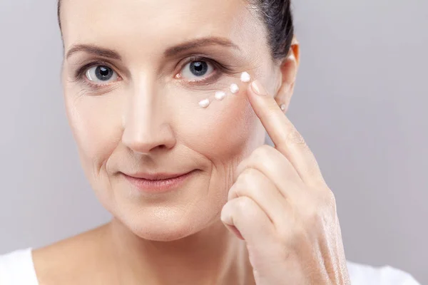 Skin Care Concept Closeup Portrait Mature Woman Applies Face Cream — Stock Photo, Image