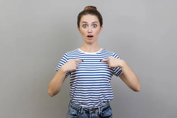 Portrait Astonished Woman Wearing Striped Shirt Pointing Herself Asks Who — Stock Photo, Image