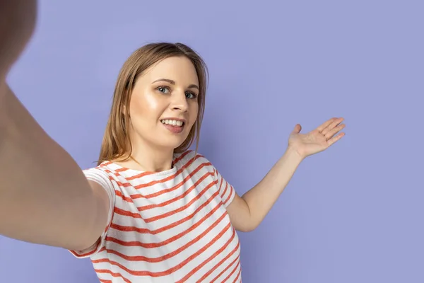 Portrait Friendly Positive Blond Woman Wearing Striped Shirt Showing Welcome — Stock Photo, Image