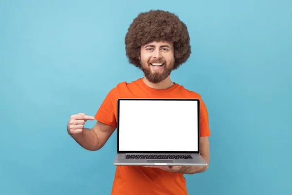 Portrait Delighted Man Afro Hairstyle Wearing Orange Shirt Standing Showing — Stock Photo, Image