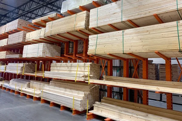 Wood factory stock or timber in warehouse. Piles of wooden boards waiting for shipping. Lumber, Business, production, manufacture and woodworking industry concept