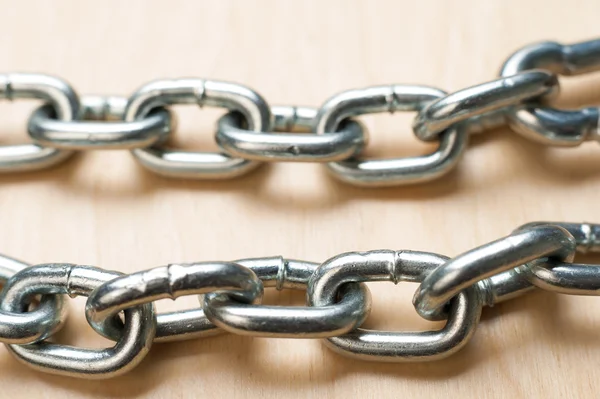 Two Chain Links on Wooden Table — Stock Photo, Image