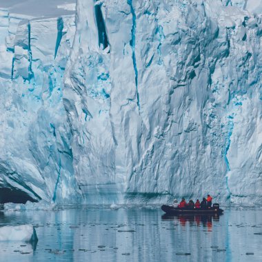 Tourists observing a glacier on the Antarctica, Paradise bay, Antartic Peninsula. clipart