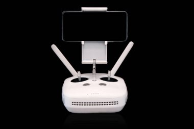 wireless joystick. drone control panel. with a phone in it. on a black background. controller