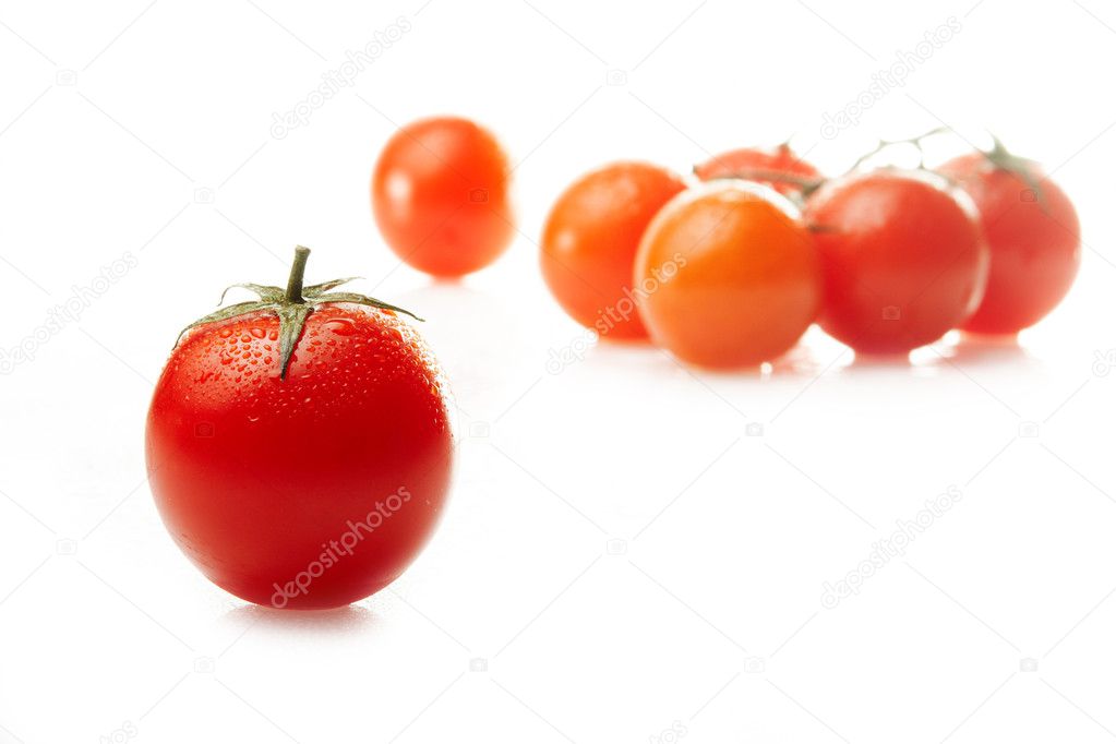 Tomato in water drops against a group