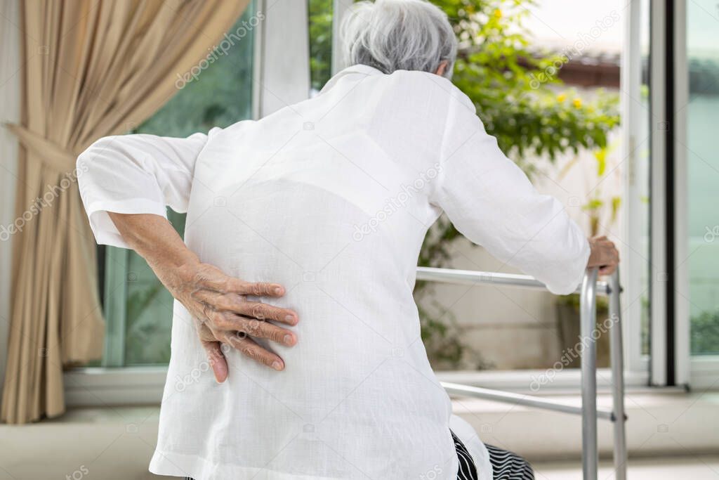 Asian senior patient with lower back pain or back muscle injury,old elderly having backache,painful of spinal joint,inflammation and degeneration of the spine and intervertebral discs,health problems