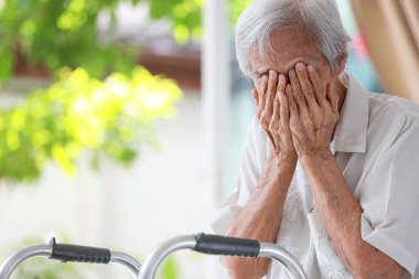 Depressed senior woman covering face with hands,Lonely old people crying alone at home,loneliness,hopelessness,dejection,Sad elderly patient with depression,mental health problems,depressive illness