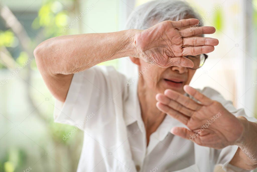 Asian old elderly woman raising hands in defence,resisting attack,victims of family domestic violence,physical mental abuse,mistreatment,harassment and assault in home,human rights violation concept