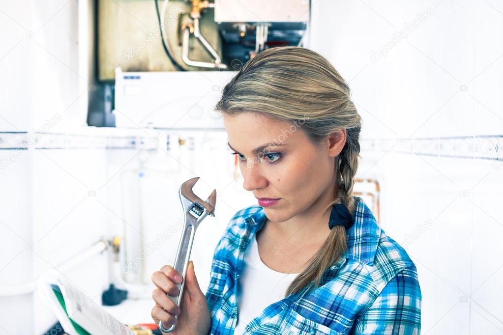 Beautiful Girl Is Learning How To Repar a Boiler Using a Pipe Wrench