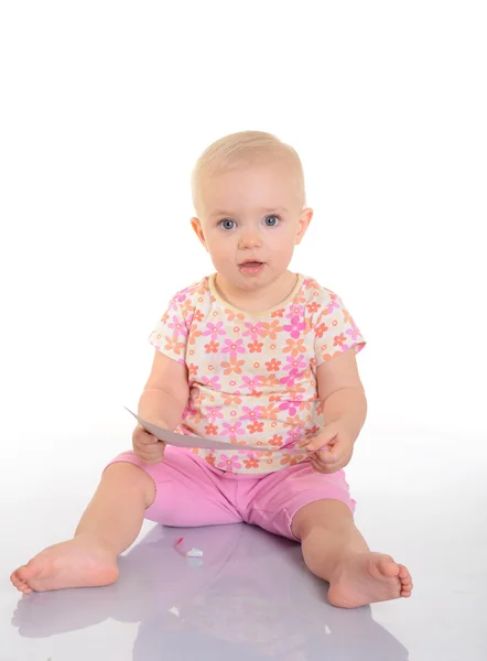 Baby playing with a picture on white background — Stock Photo, Image