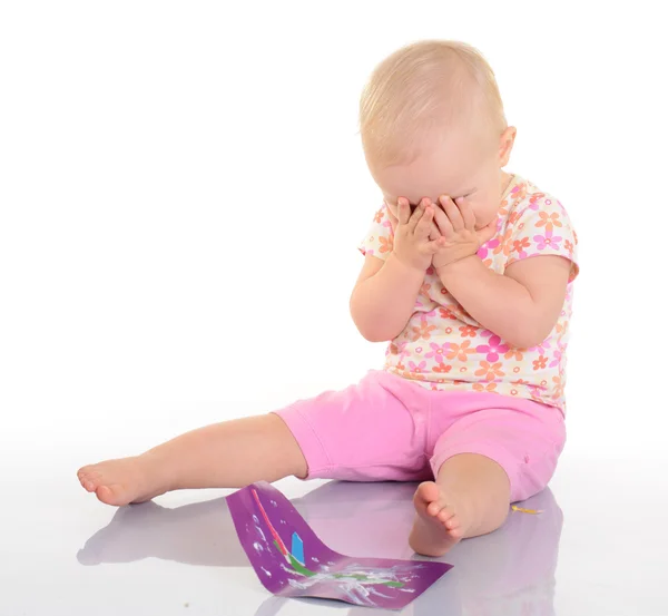 Baby playing with a picture on white background Stock Photo