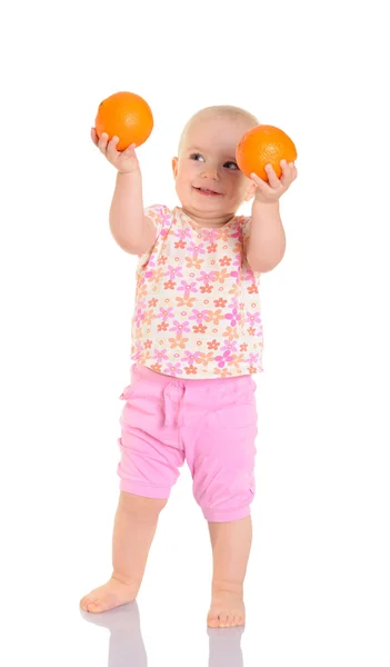 Glückliches Baby mit Orangen auf weißem Hintergrund — Stockfoto