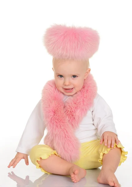 Cute baby in pink fur sitting on white background — Stock Photo, Image