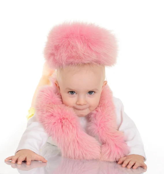 Cute baby in pink fur lying on white background — Stock Photo, Image