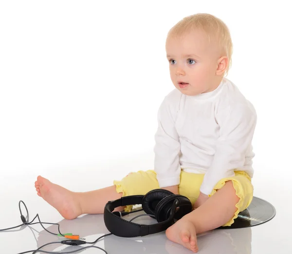 Baby playing with headphones on white background — Stock Photo, Image