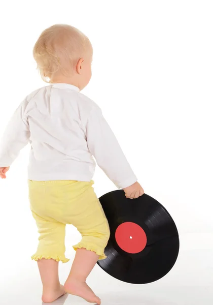 Baby playing with old vinyl record on white background — Stock Photo, Image