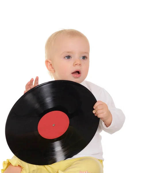 Cute baby playing with old vinyl record on white background — Stock Photo, Image