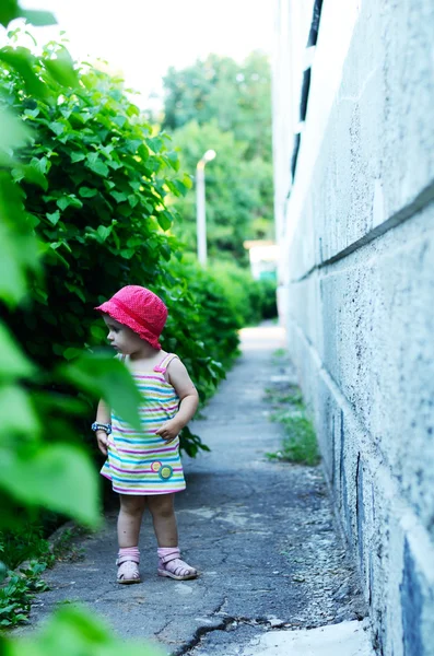 Słodkie dziecko stoi przy ścianie — Zdjęcie stockowe