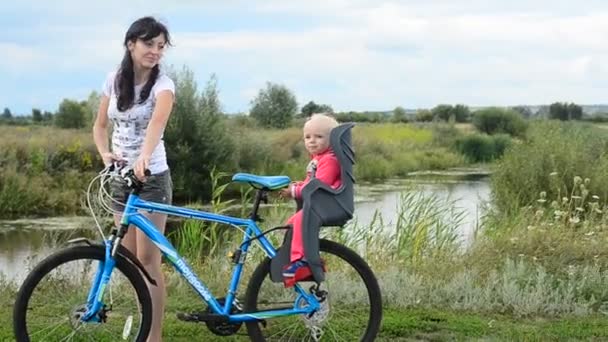 Little girl sitting in bicycle chair — Stock Video