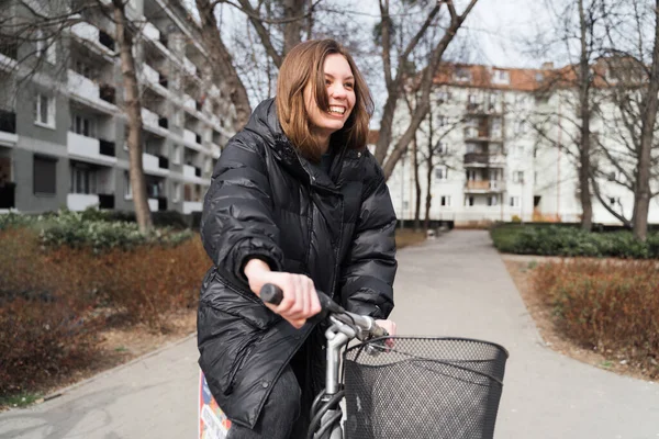 Smiling happy girl using a bicycle by bike-sharing service. Lifestyle female student renting a bike like an alternative public transport. Eco concept — Stock Photo, Image