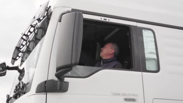 Homem caucasiano de meia idade motorista de caminhão. Alemanha emprego para a Europa camionista de transportes. Cabine do camião de carga — Vídeo de Stock