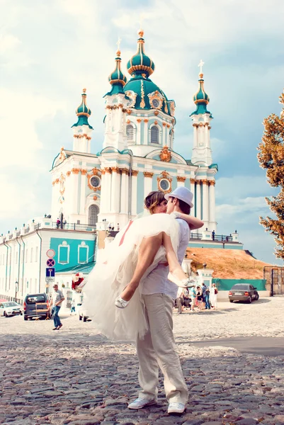 Fiancee and groom, sitting near a church — Stock Photo, Image