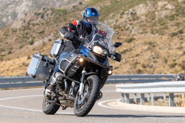 Asfaltta yatan bir motosikletli. Fotoğraf 26 Ekim 2020 'de Avila, Spai' deki Navalmoral limanında çekildi.