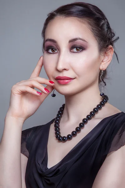 Asia girl with red nails and black beading — Stock Photo, Image