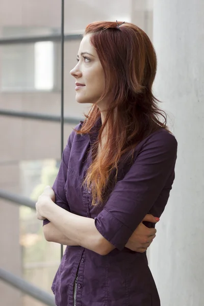 Teacher standing at window smling - gazing upward — Stock Photo, Image